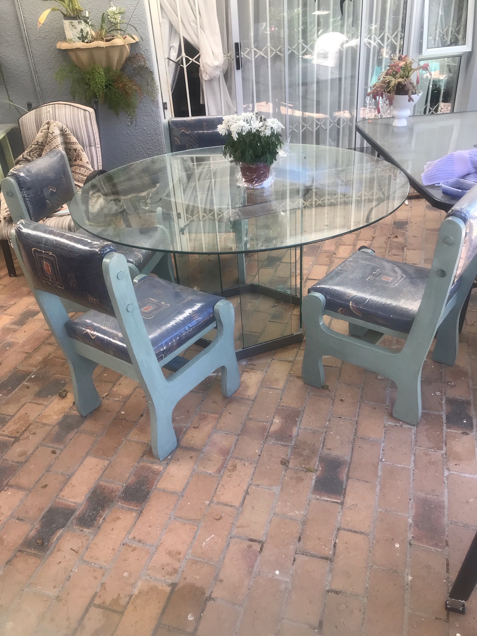 round glass table and four chairs