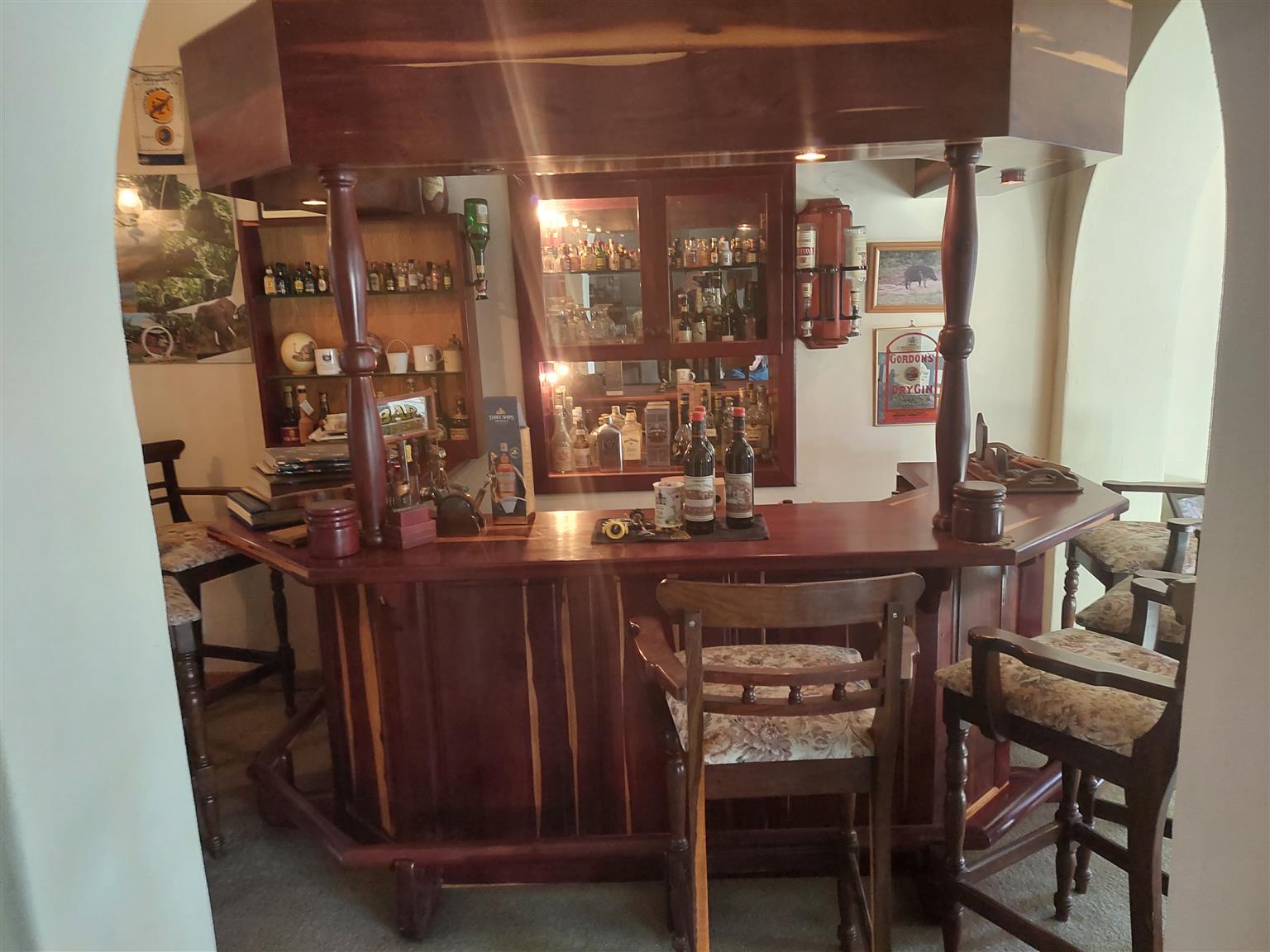 Mopani wood Bar complete with cabinets below, foot rest, with Leadwood Stools to