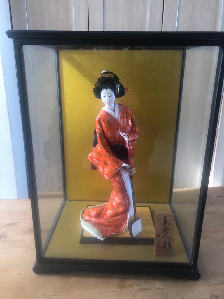 japanese doll in glass case