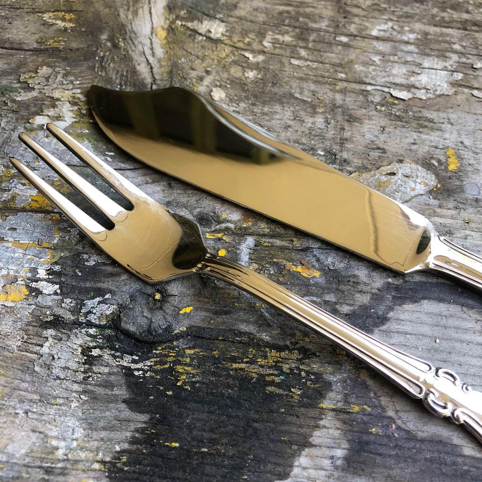 Large Vintage clear pressed glass cake stand with a silver plated cake knife and fork.