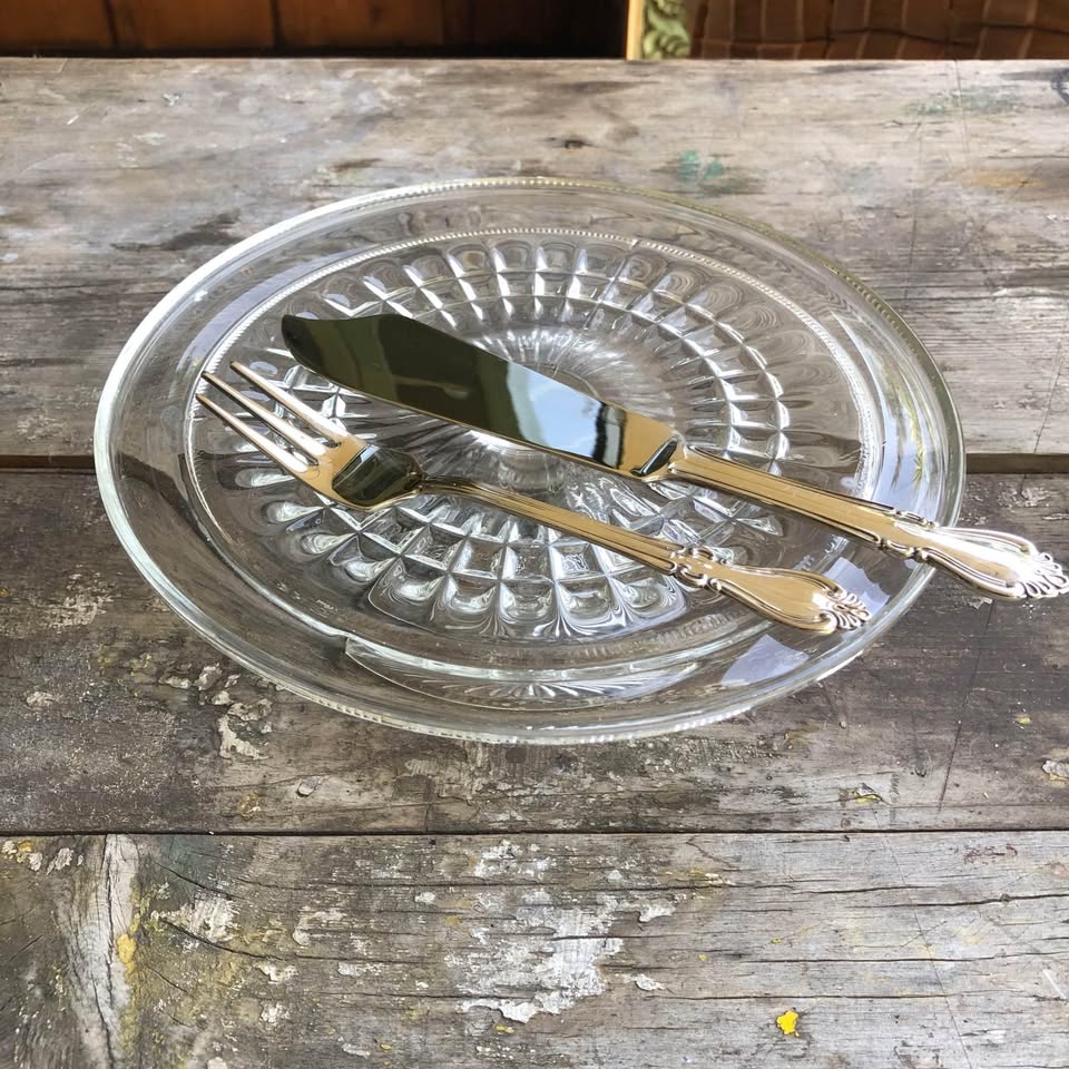 Large Vintage clear pressed glass cake stand with a silver plated cake knife and fork.