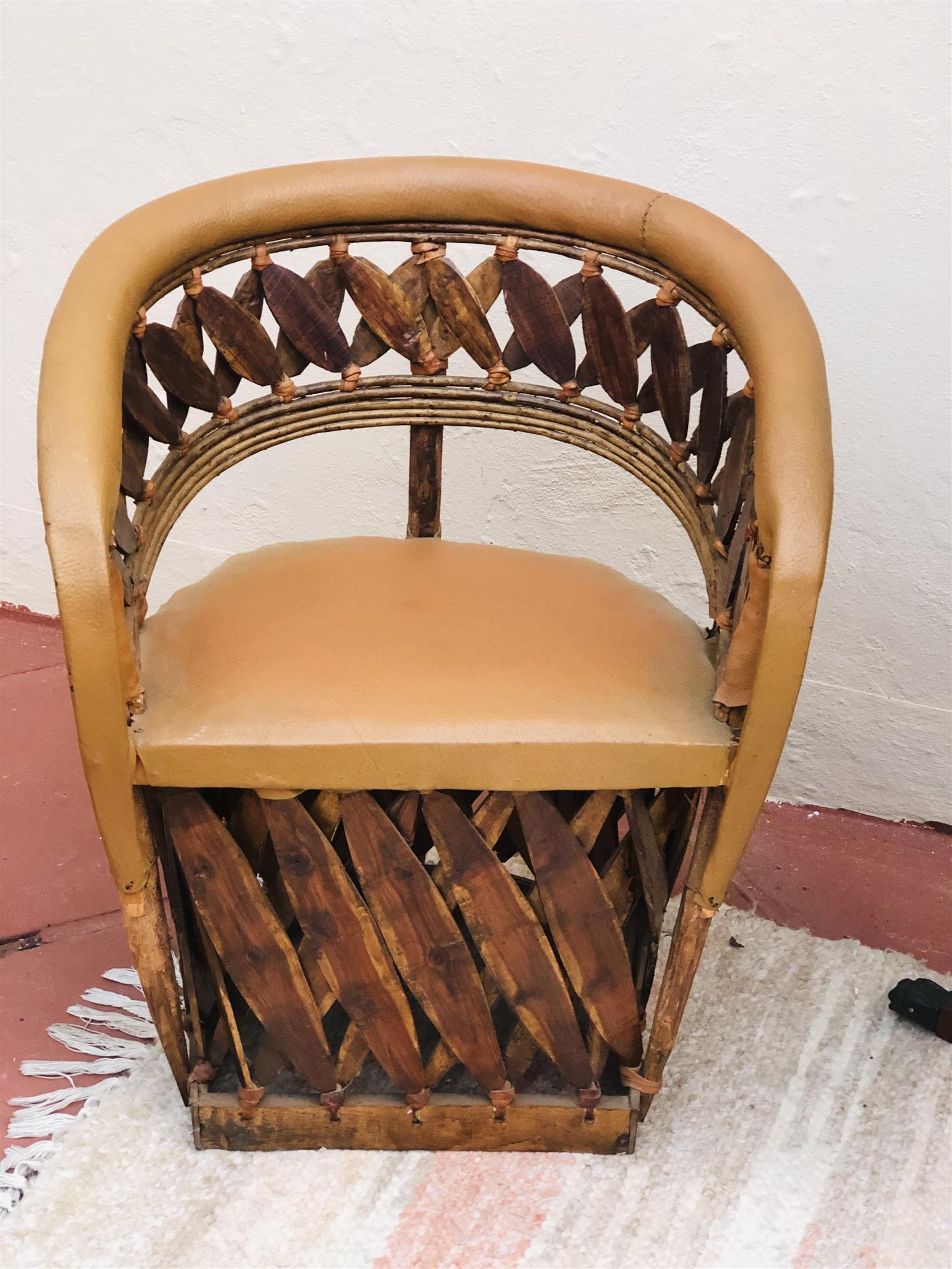 Pair of unique African carved tub chairs with genuine leather finish 