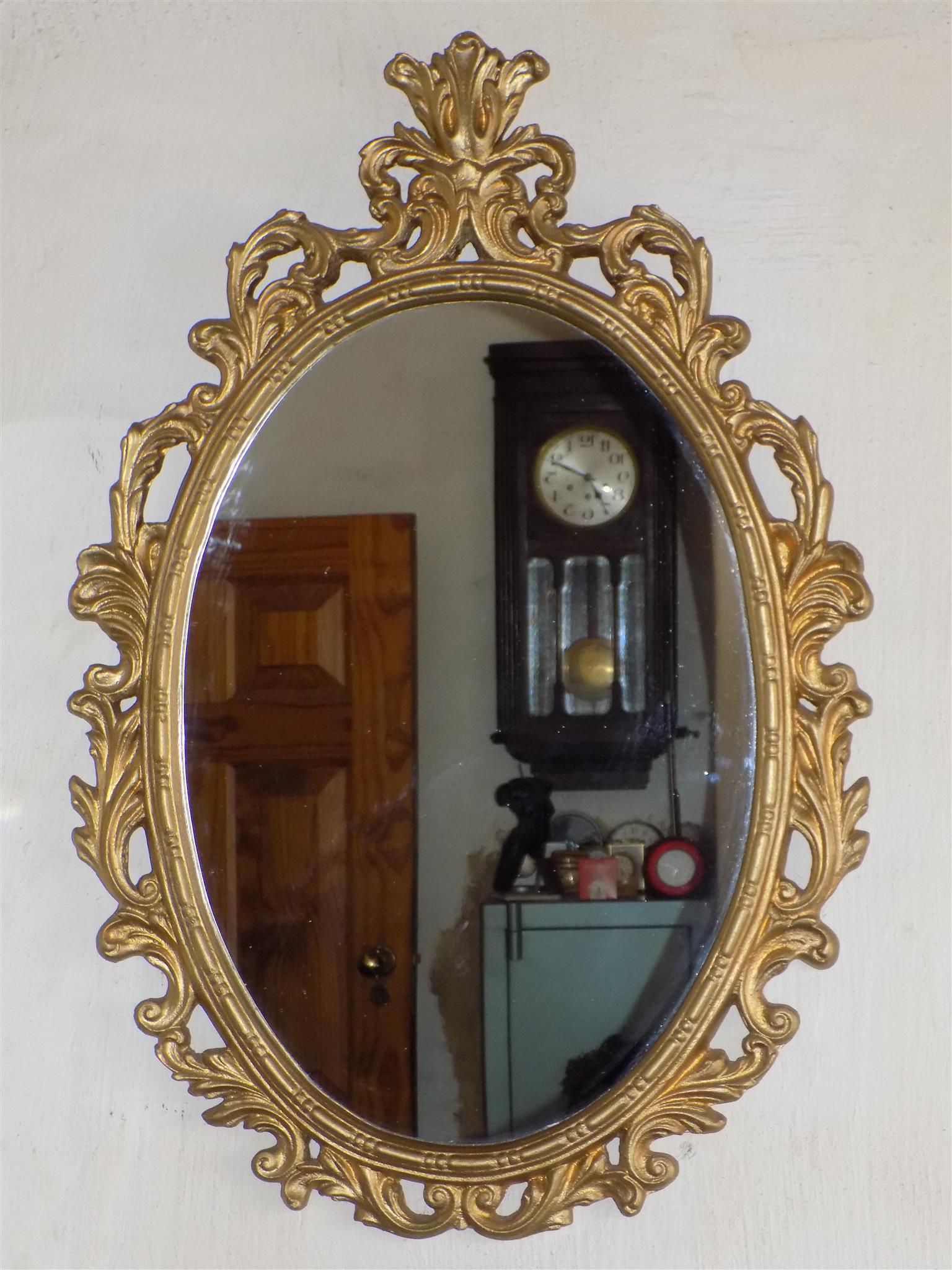 Oval ornate gilt wood mirror Oval ornate gilt wood mirror