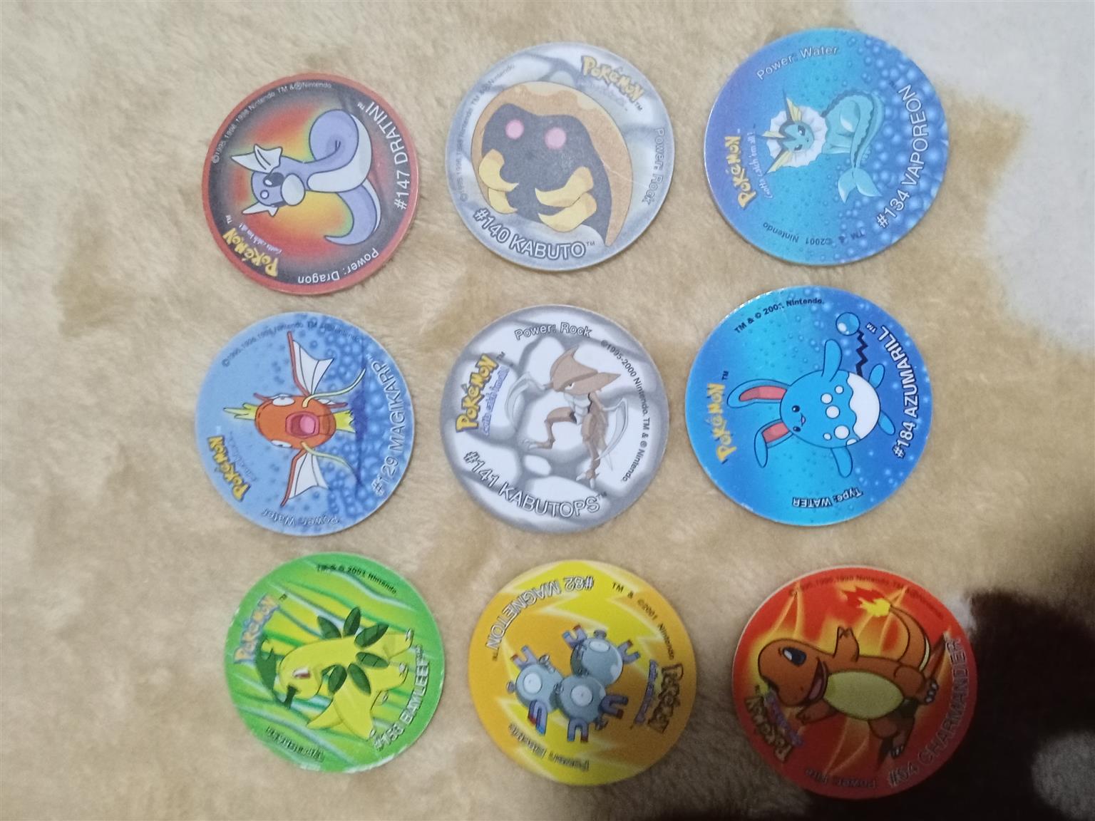 83× Pokemon Tazos with holder