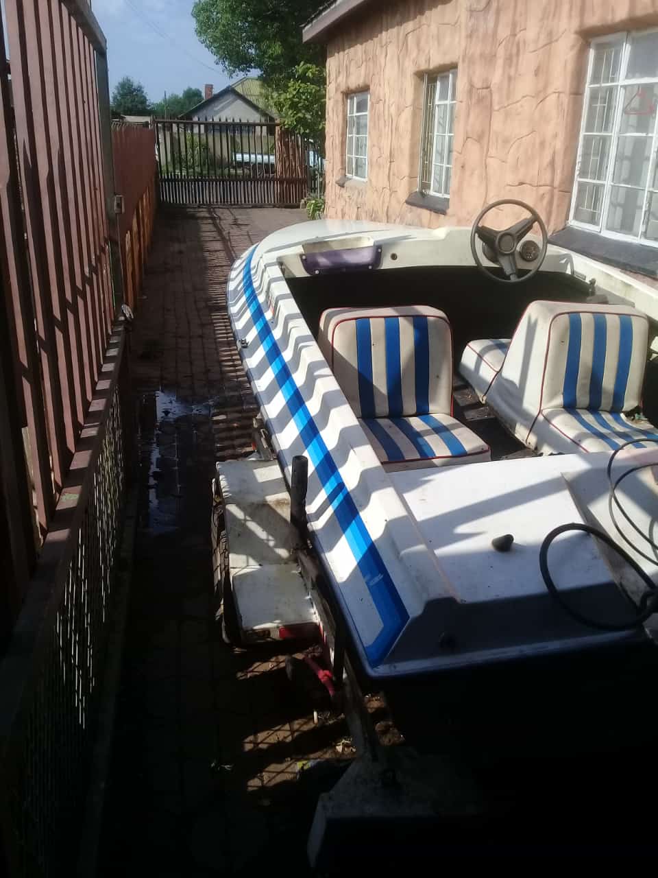 Motorboat with 40 cc Suzuki outboard motor and trailer