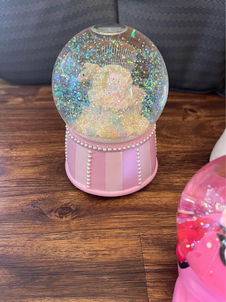 Collection of pink snow globes