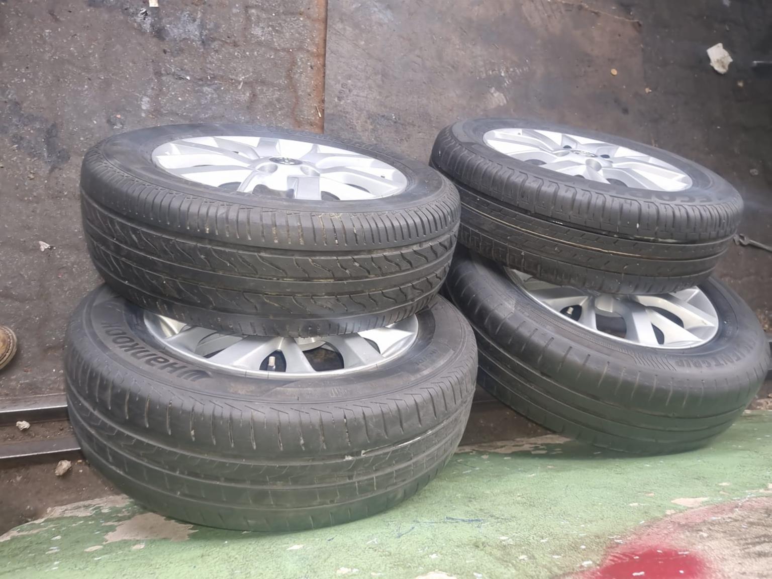 15inch Nissan Almera original mags with used 185/65/15 tyres set for - Private Seller