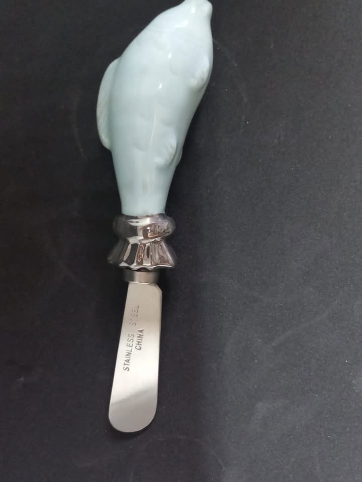 Butter/Cheese knives with ceramic dolphin handles.