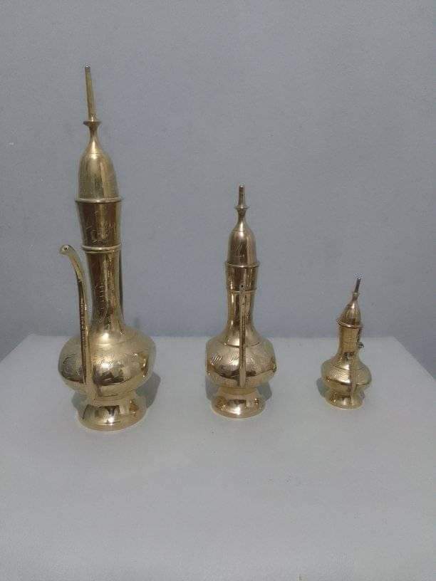 A set of 3 brass kettles