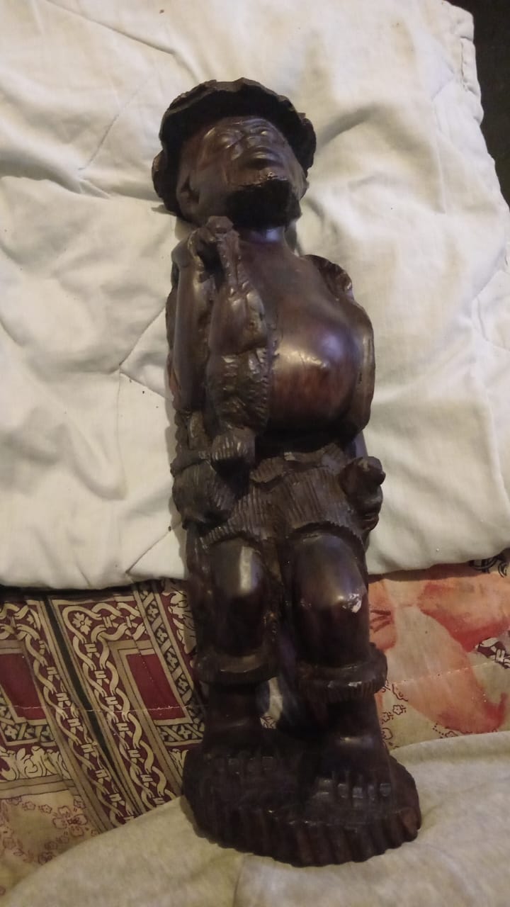 Wooden carved statue of a traditional African fisherman Wooden carved statue of a traditional African fisherman