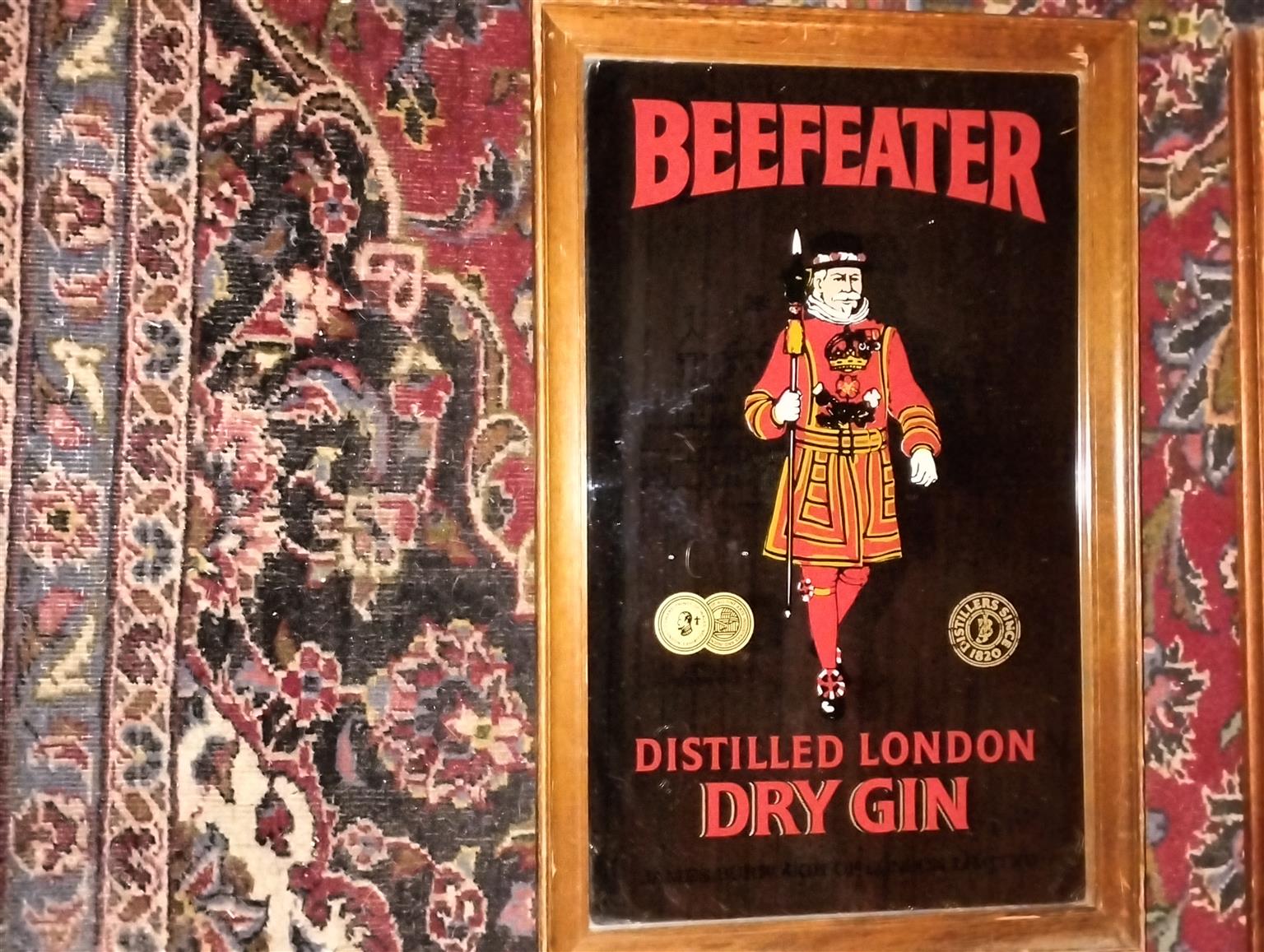 Vintage bar mirror with various alcohol logos