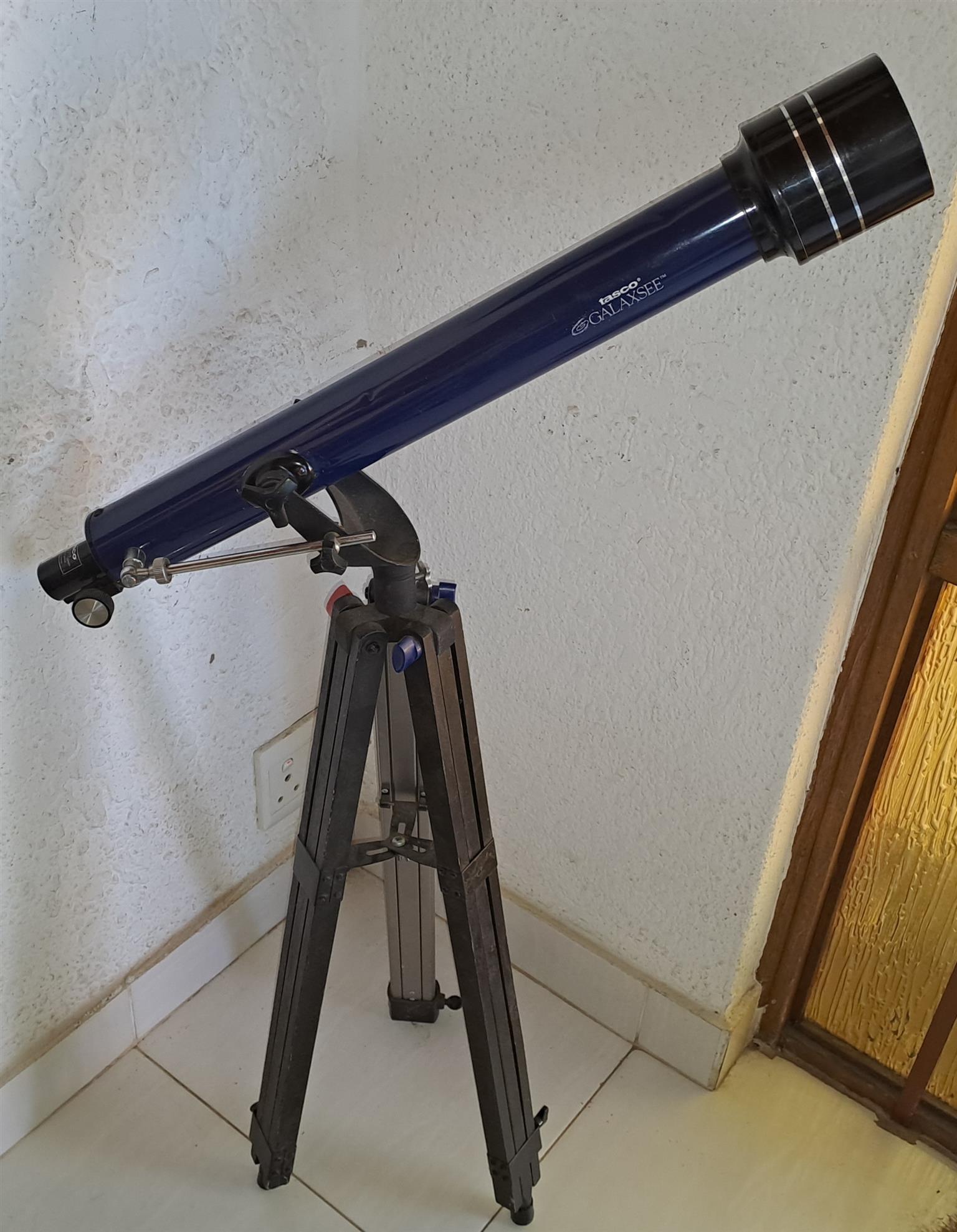 Large telescope. On light weight tripod. Large telescope. On light weight tripod.
