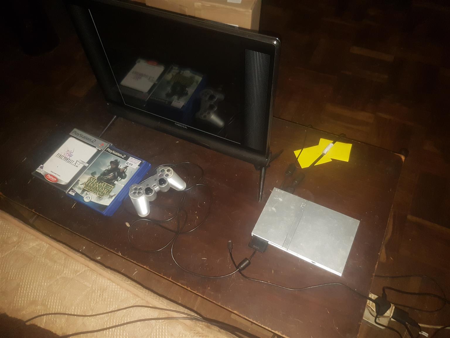 Playstation 2 and TV with games for sale