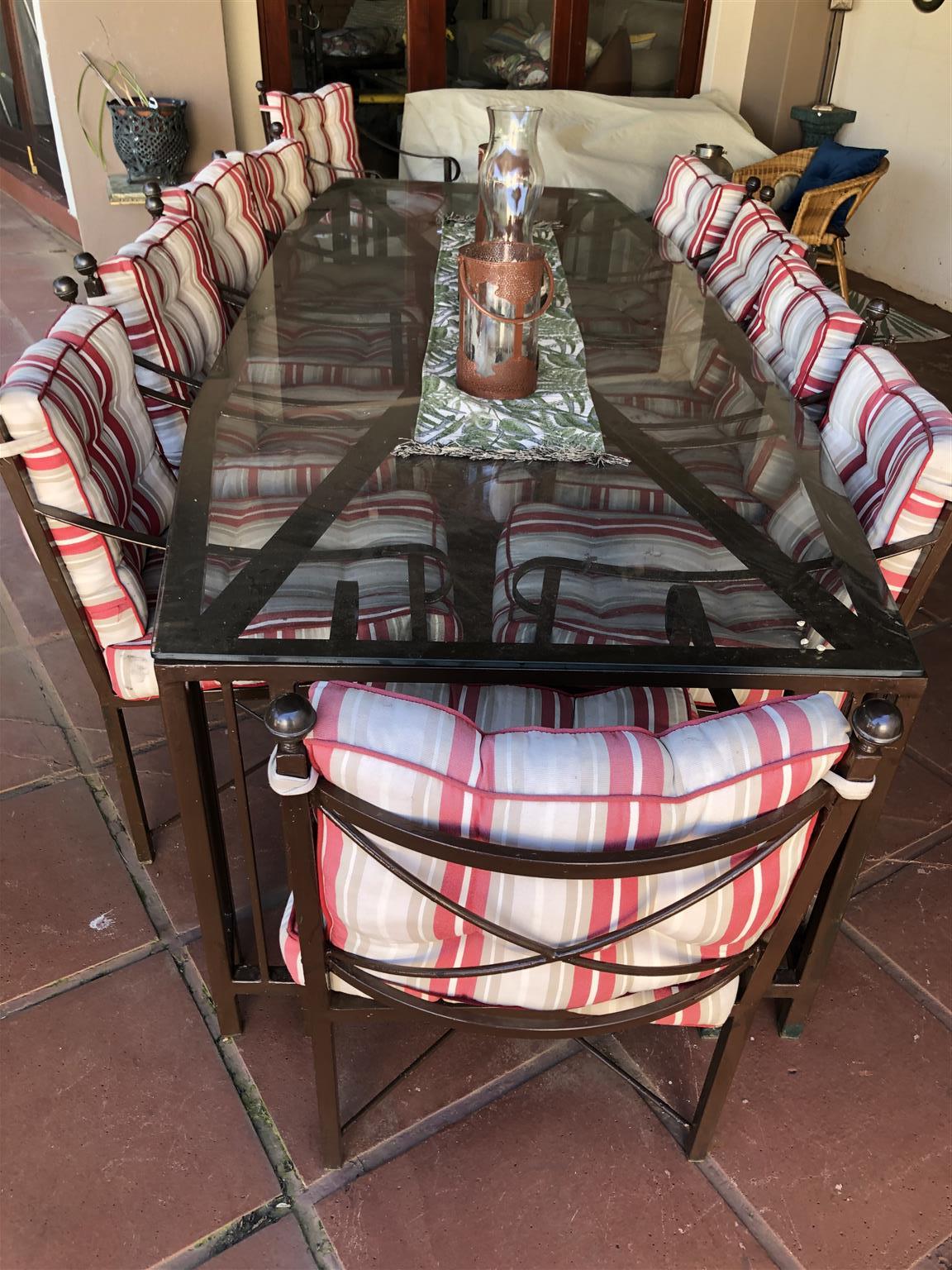 wrought iron table with glass top and chairs