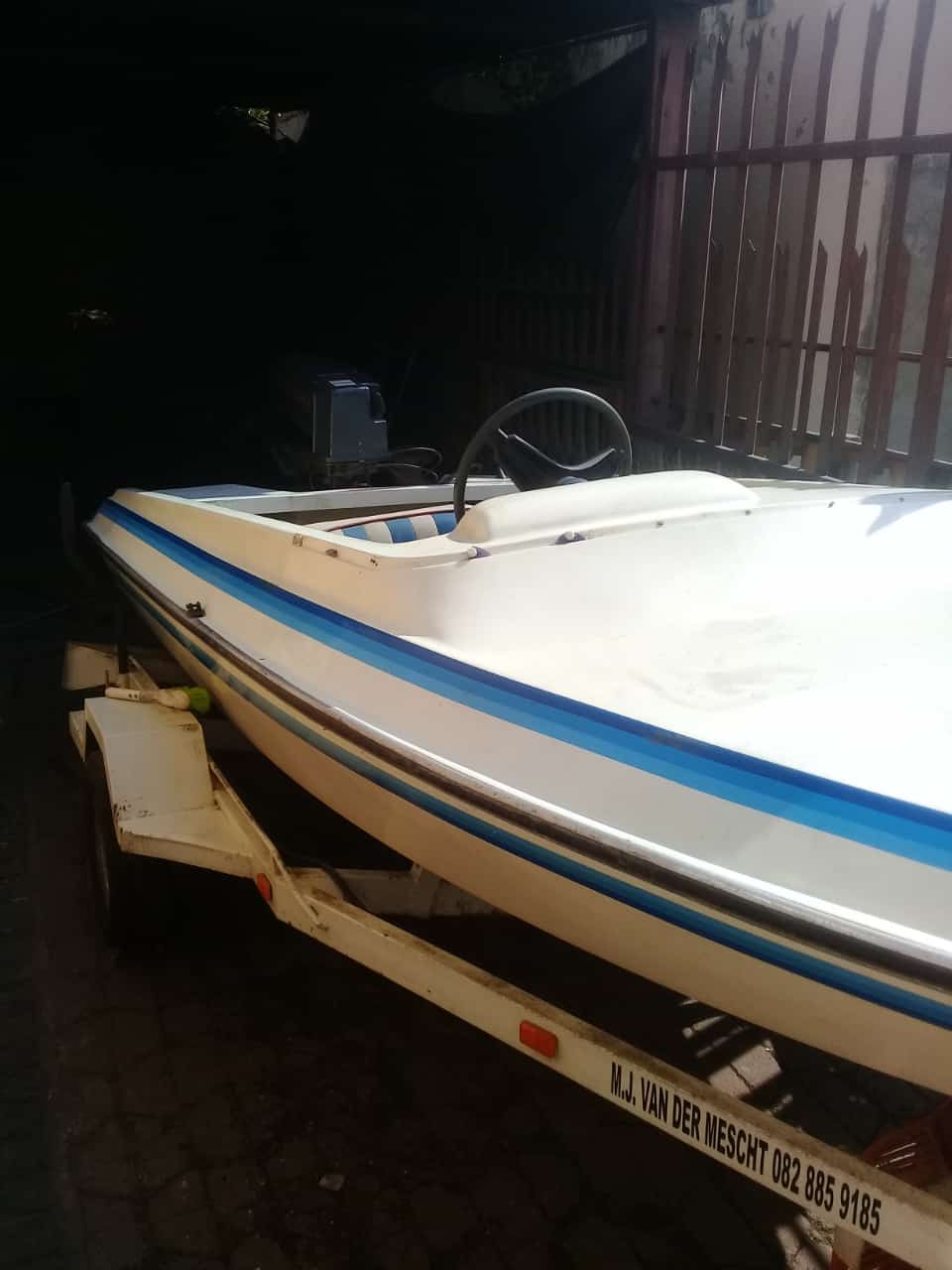 Motorboat with 40 cc Suzuki outboard motor and trailer
