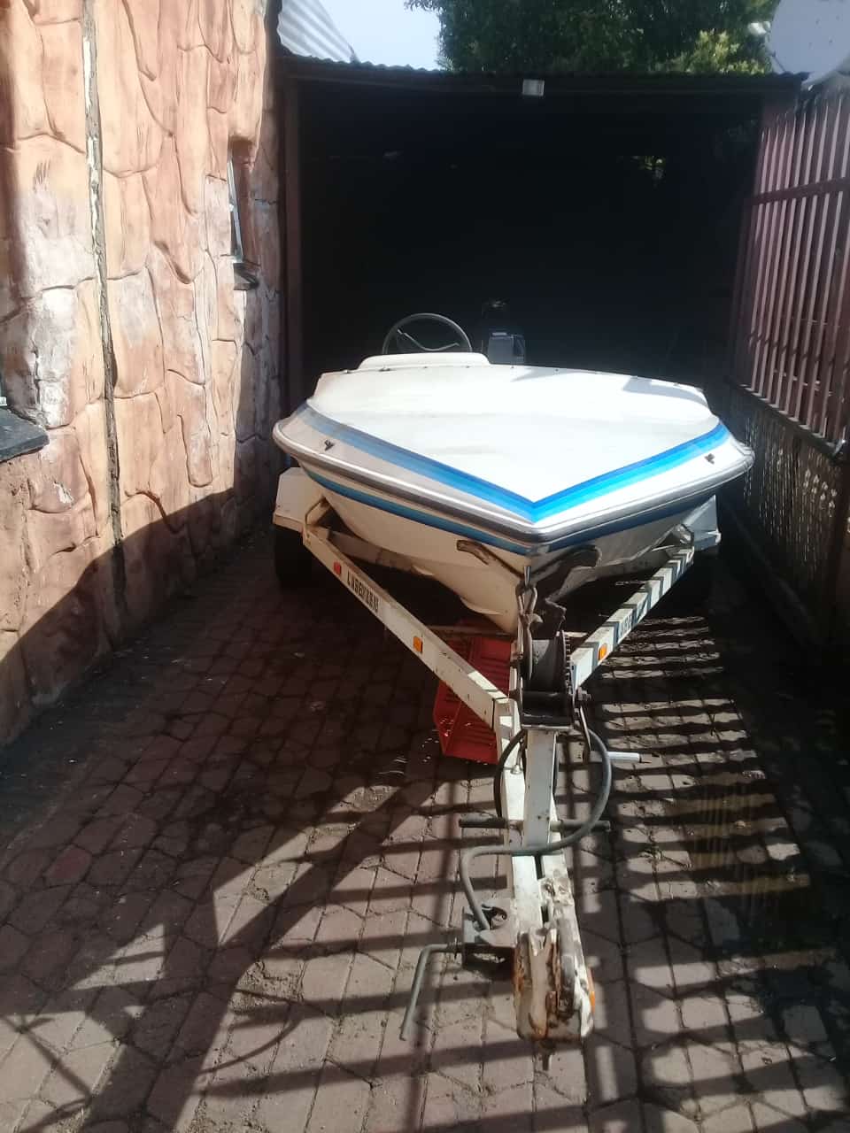 Motorboat with 40 cc Suzuki outboard motor and trailer