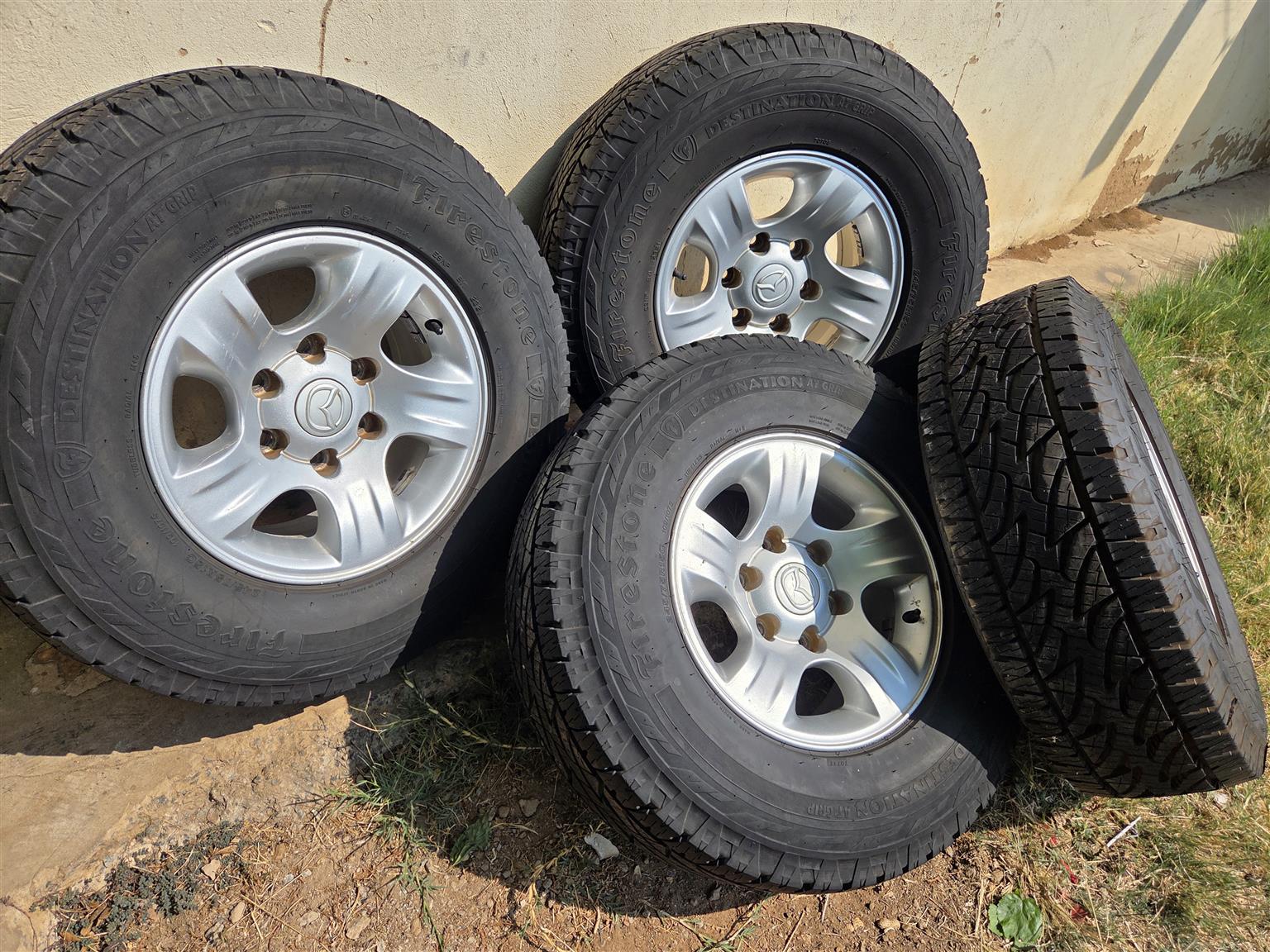 Mazda mags size 15 set tyres 90% firestone - Private Seller