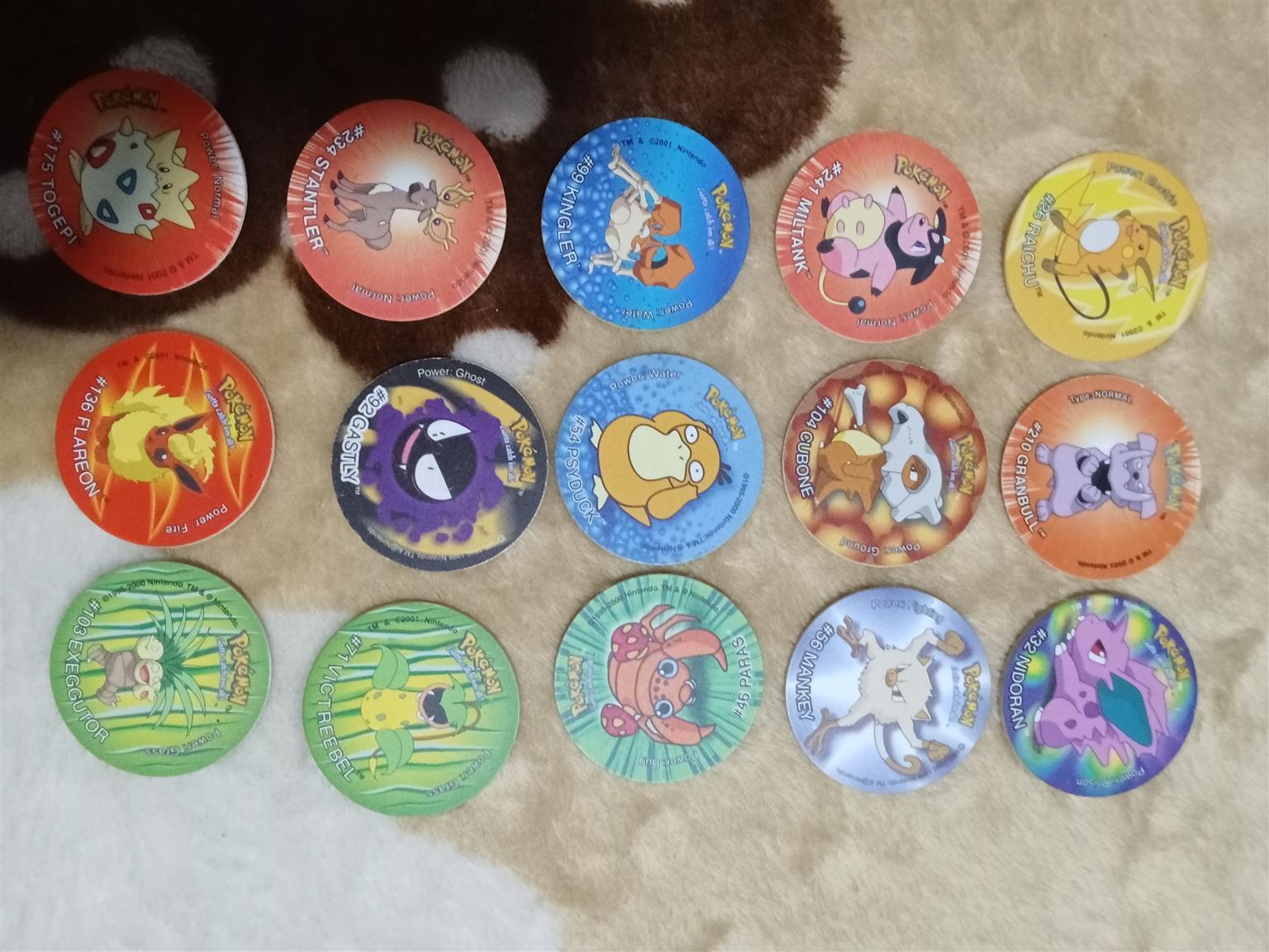 83× Pokemon Tazos with holder