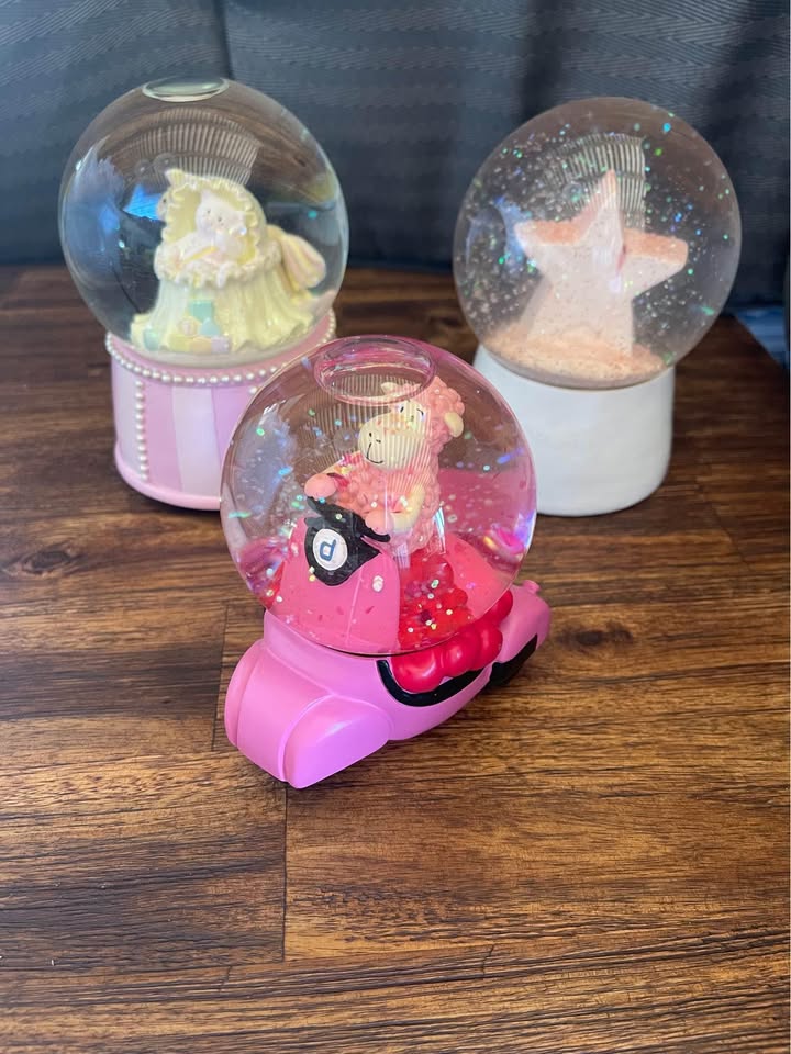 Collection of pink snow globes Collection of pink snow globes