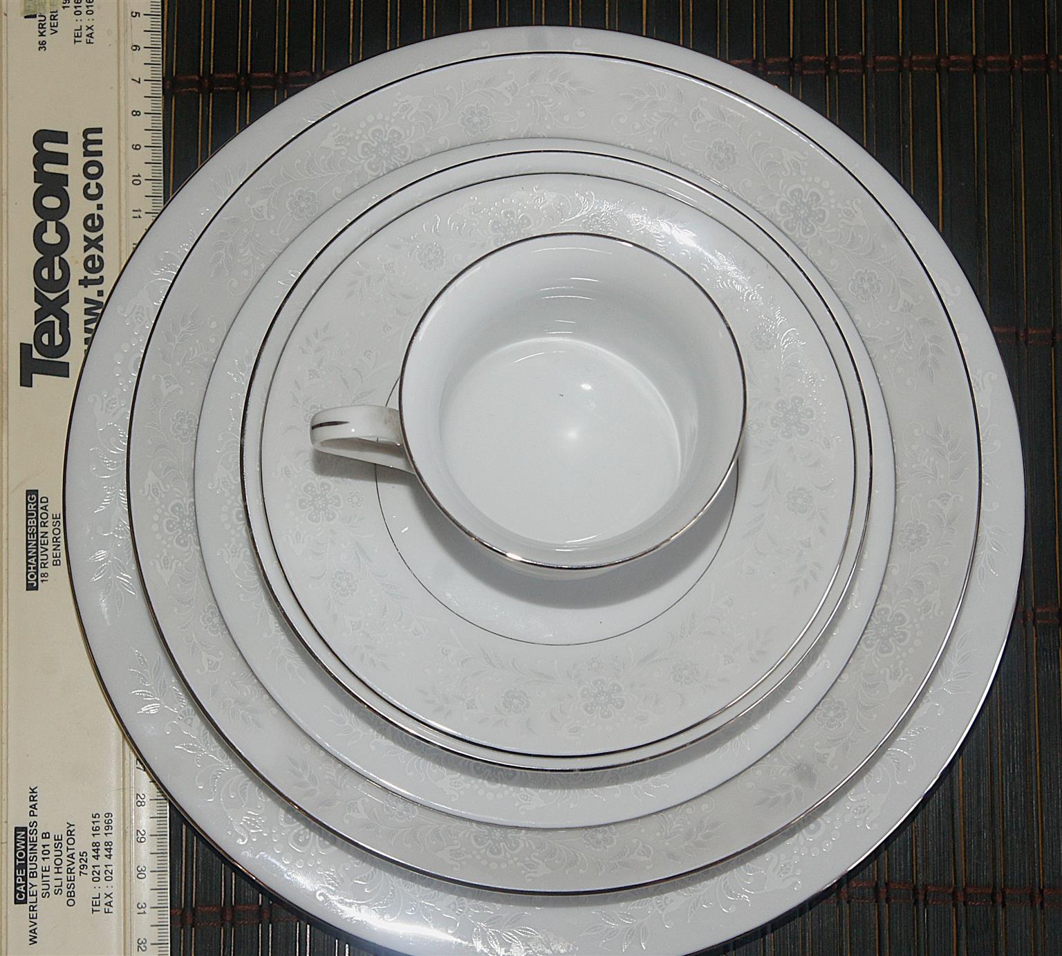 Elegantly beautiful Fine China 72 Piece Dinner Set in. Silver and White