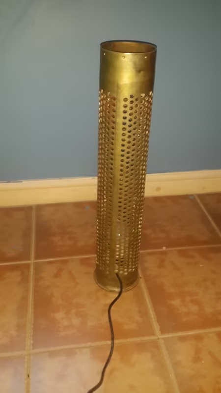 Ordnance  shell repurposed to a standing light in good condition. Ordnance  shell repurposed to a standing light in good condition.