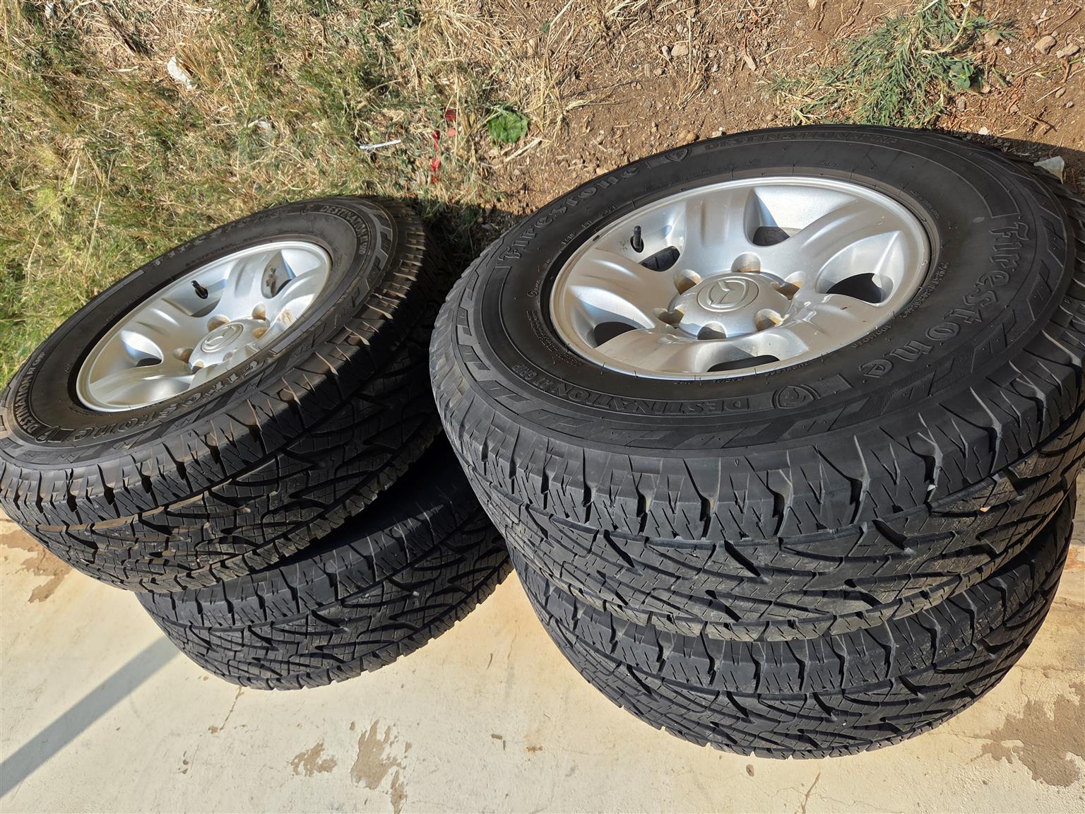 Mazda mags size 15 set tyres 90% firestone - Private Seller