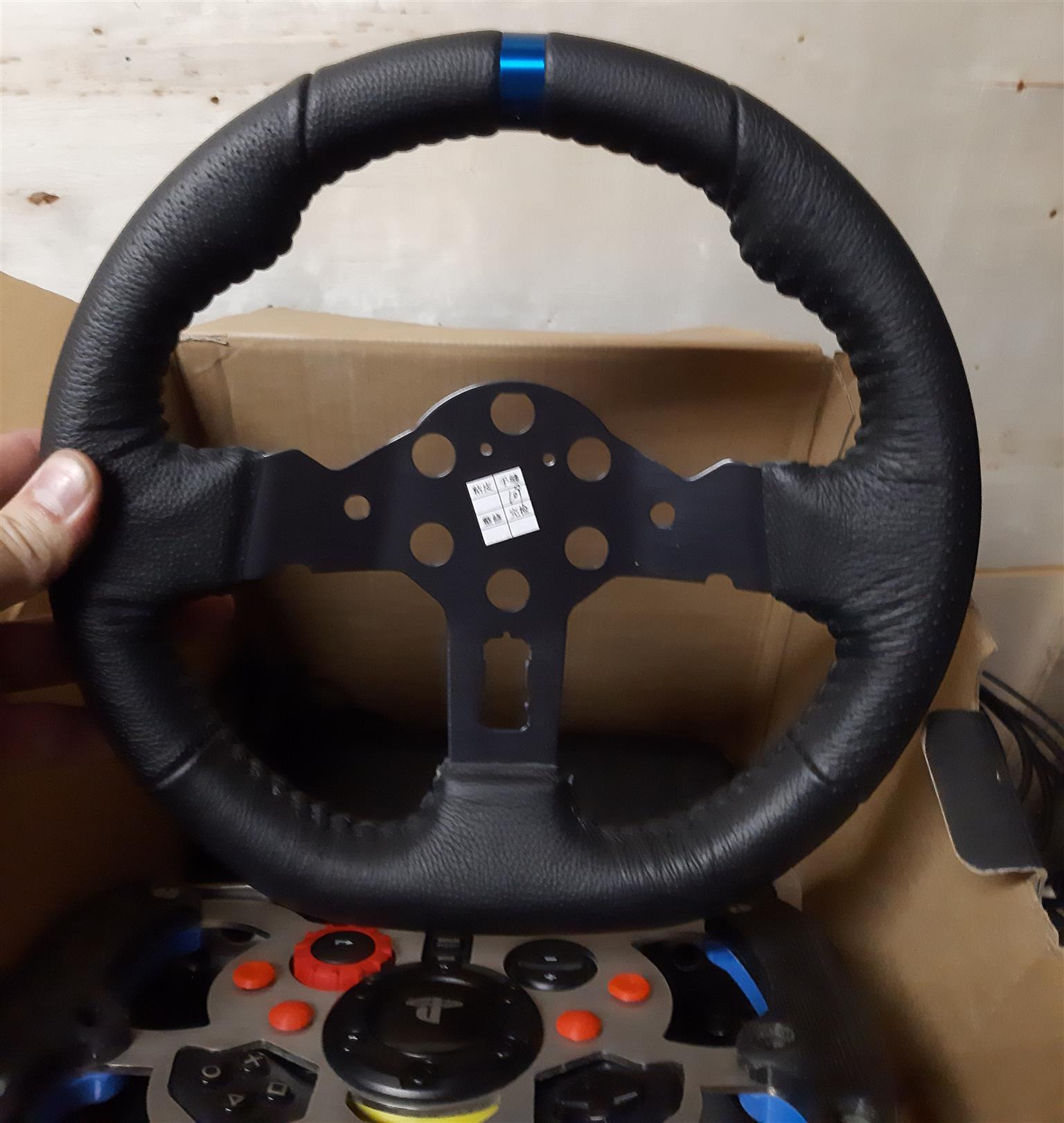 LOGITECH G29 steering wheel with pedals, gear shifter, and accessories
