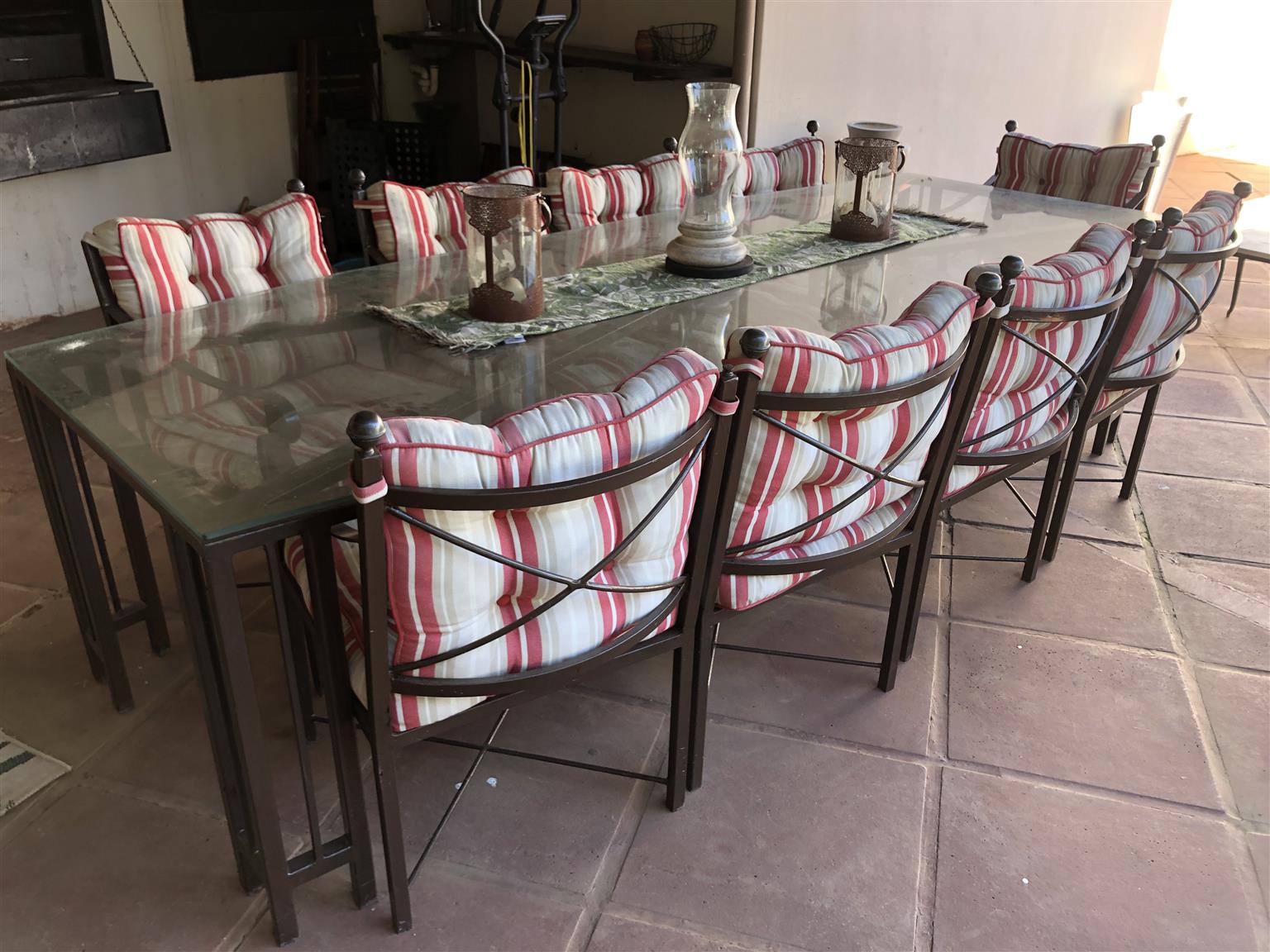 wrought iron table with glass top and chairs