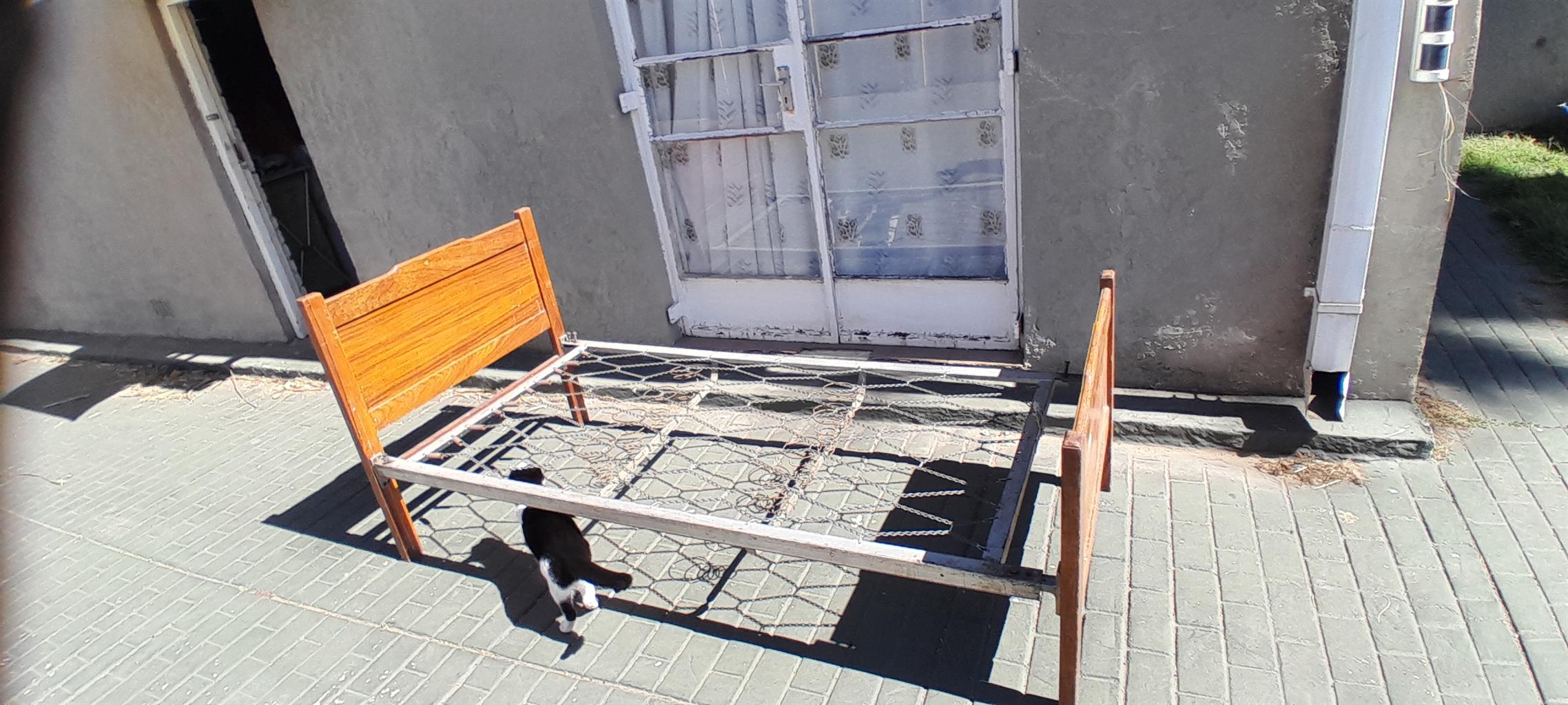 Steel single bed with wooden boards