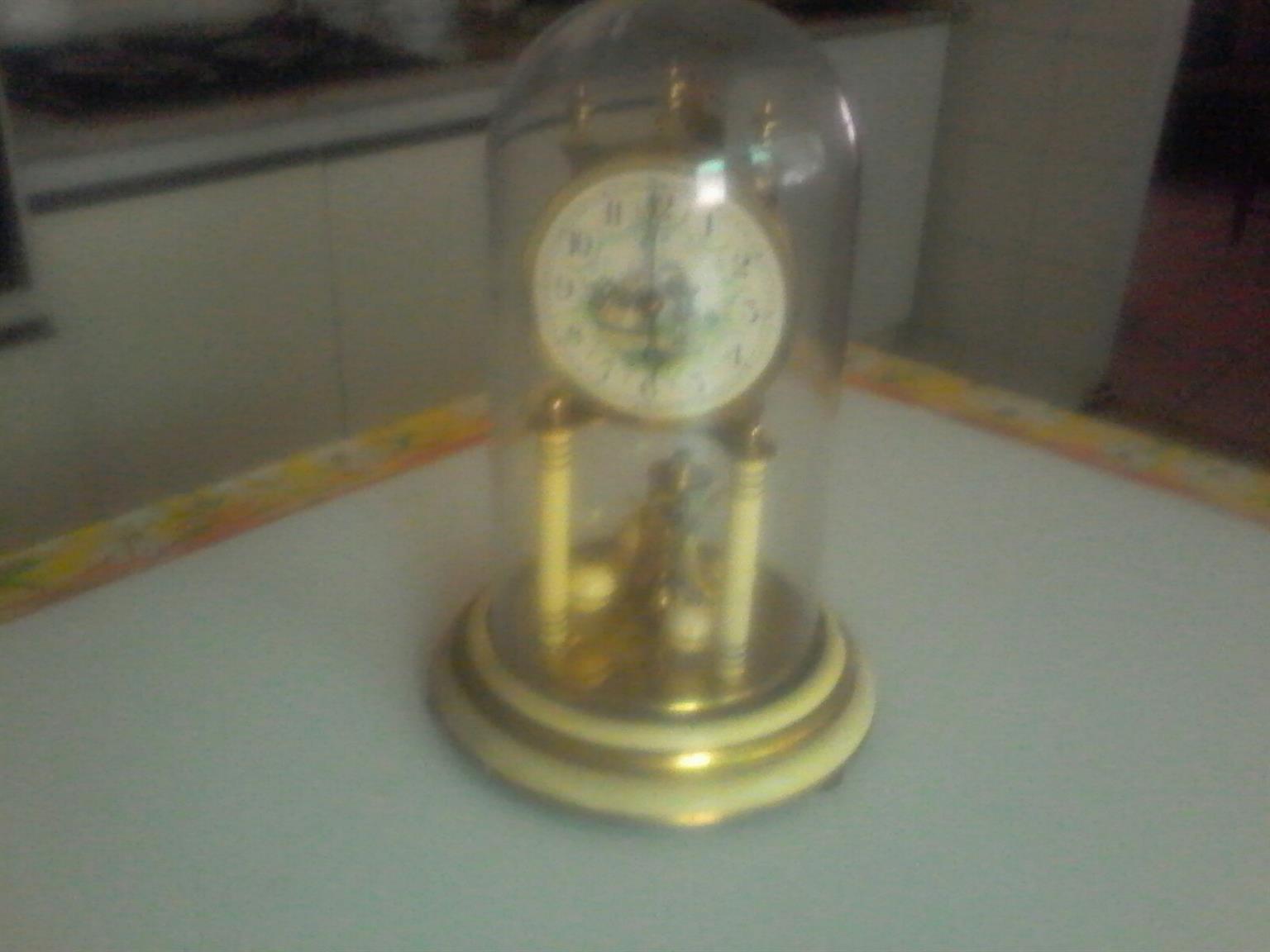vintage ornamental clock with glass dome