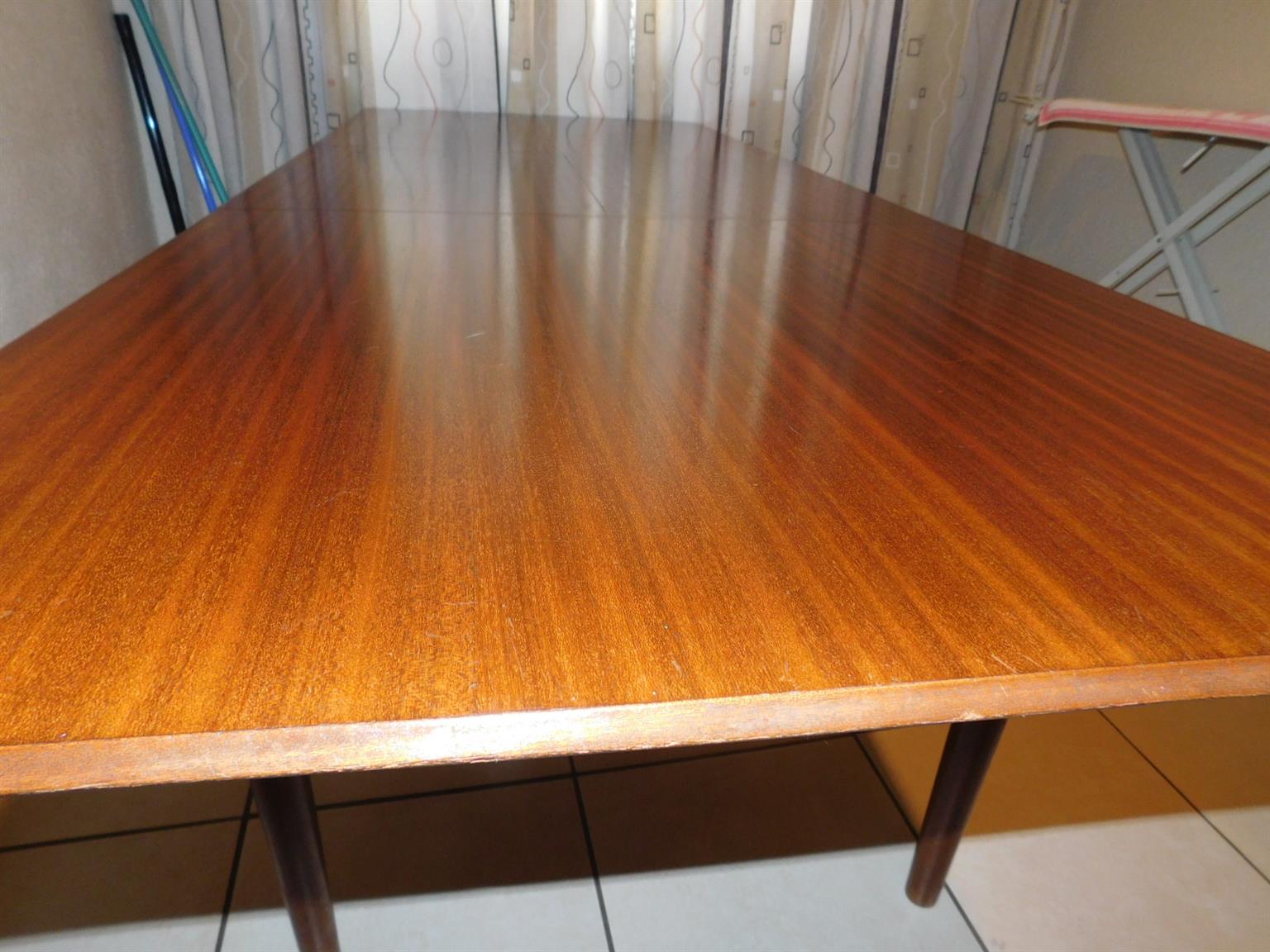 A beautiful, Imbuia, 8 seater dining room table with a fold-under extension.