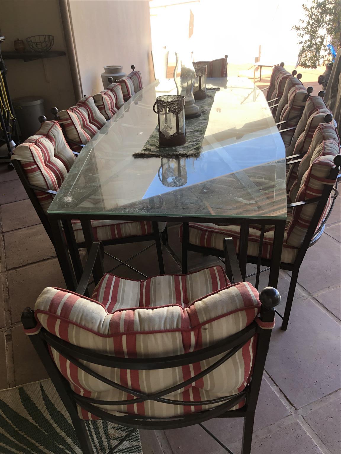 wrought iron table with glass top and chairs