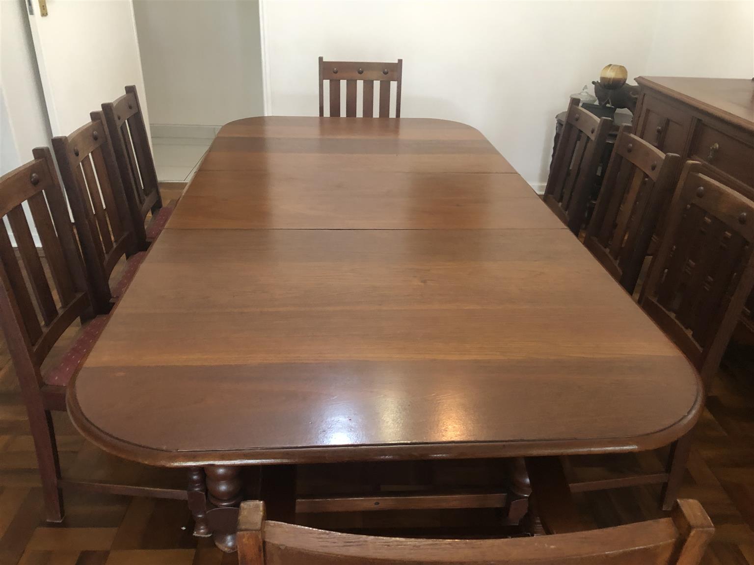 Teak eight seater dining room table with sideboard cupboard and drawers. Antique