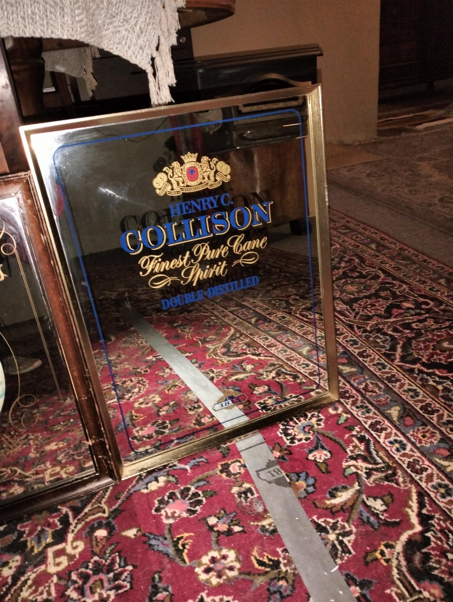 Vintage bar mirror with various alcohol logos