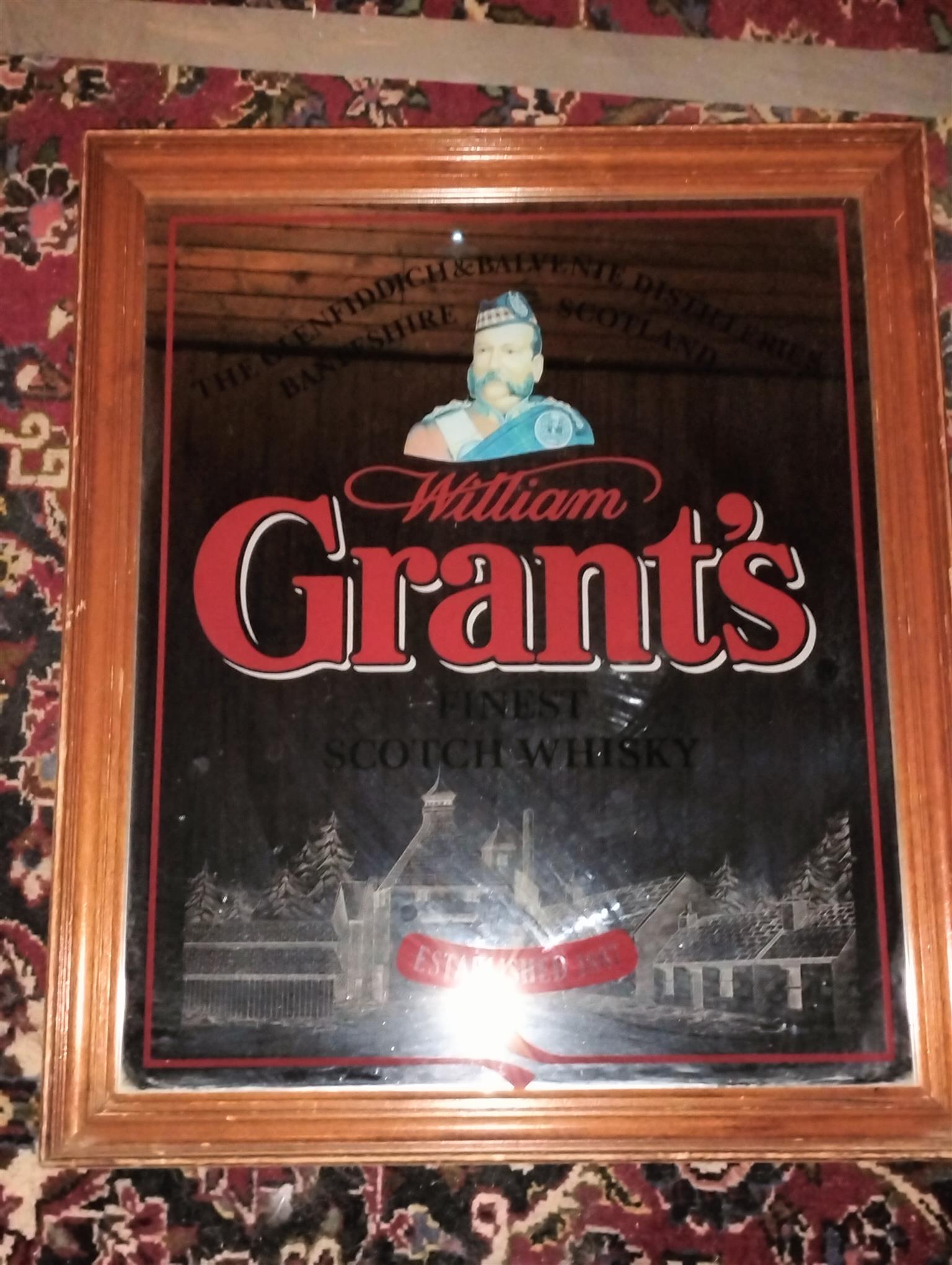 Vintage bar mirror with various alcohol logos