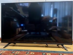 As new 50" Hisense TV on stand