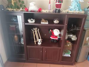 Wooden TV unit with glass doors and lights inside doors