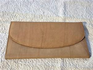 A tan genuine leather bi-fold wallet/purse.