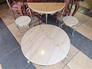 One set of four marble and brass tables