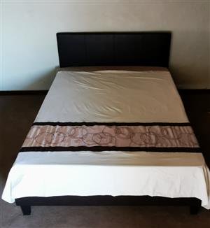Double wooden bed with mattress. 