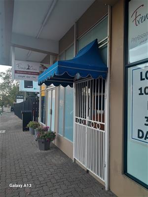Shop front electronic security gate and awning
