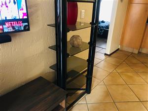 Selling a huge tv stand in black with 4 glass shelves on either side