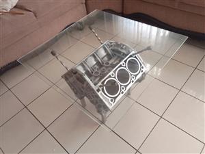 A recycled Merecedes engine block made into a rustic coffee table.