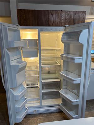 Kenmore white side-by-side refrigerator-freezer with ice and water dispenser on 