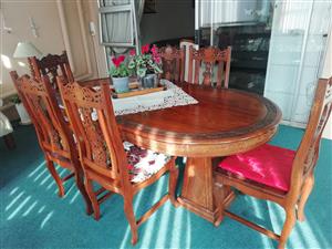 Diningroom table with 6 chairs. Beautiful wood carved rosewood. 
