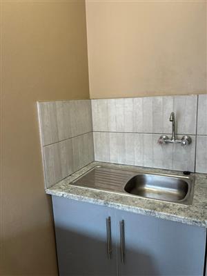 A bachelor room with toilet and shower inside