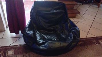 Two black bean bag chairs (poofs)