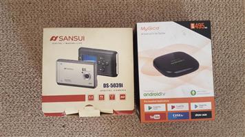 MyGica 4k Android TV Top Box and Sansui digital camera. 