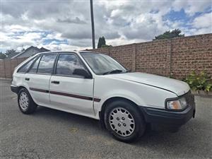 FORD LASER MANUAL. HATCHBACK.  ORIGINAL.  DRIVING