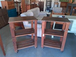 Two, wooden, three-tier kitchen islands on casters